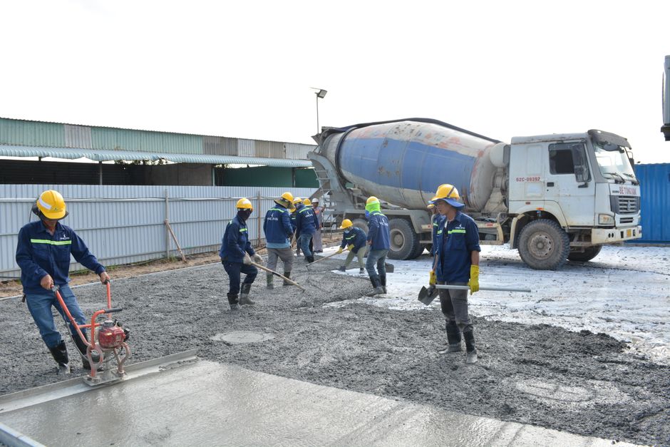 Concrete mixer truck pouring at a construction site