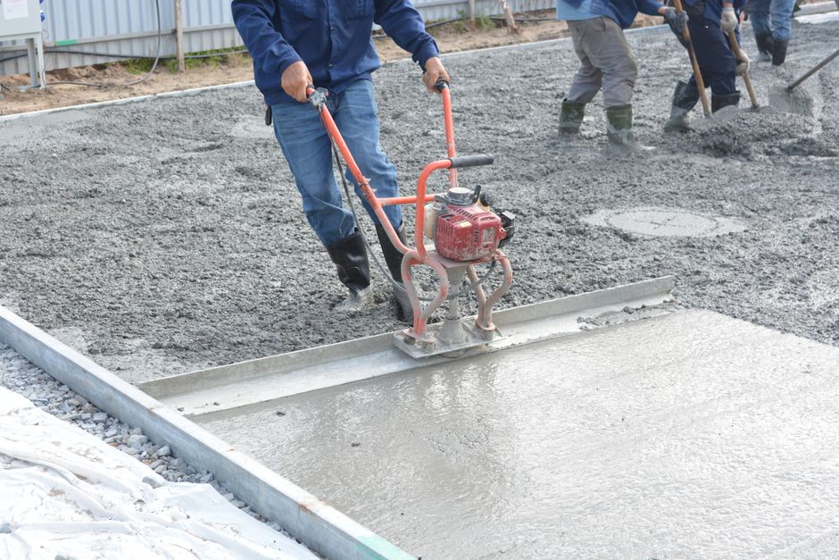 New concrete driveway being poured and finished